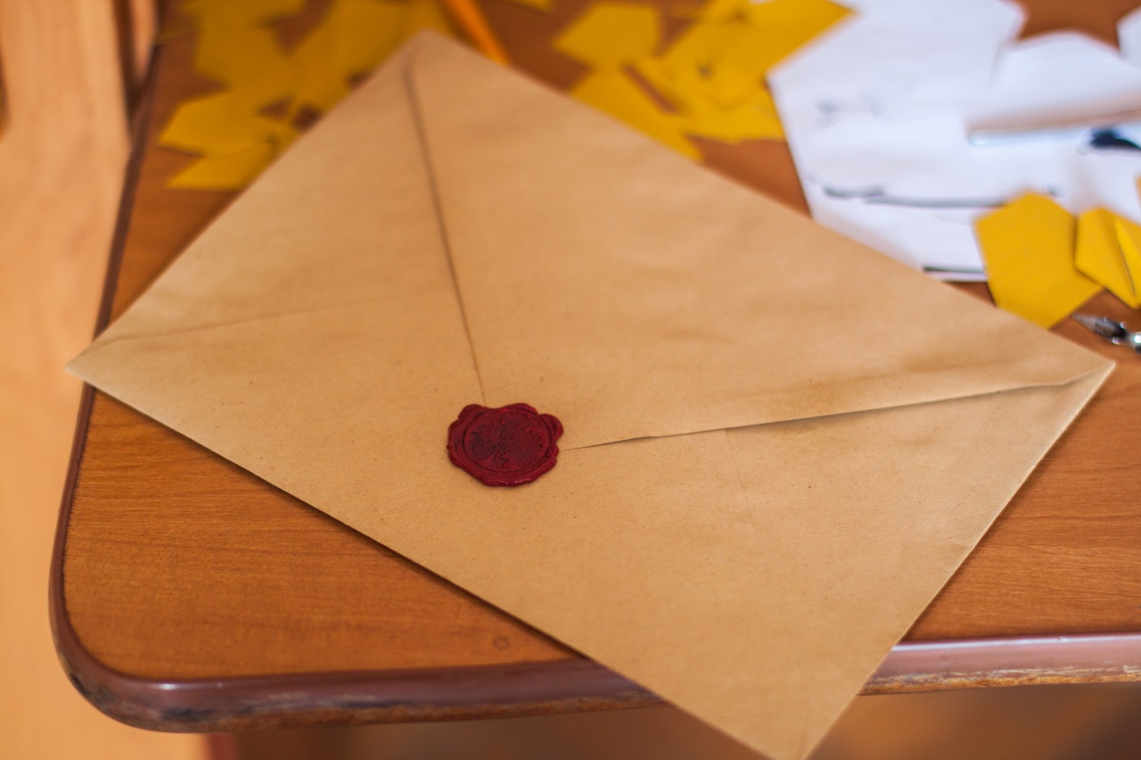 A sealed envelope placed on top of a table | photo credit: pexels.com (John-Mark Smith)