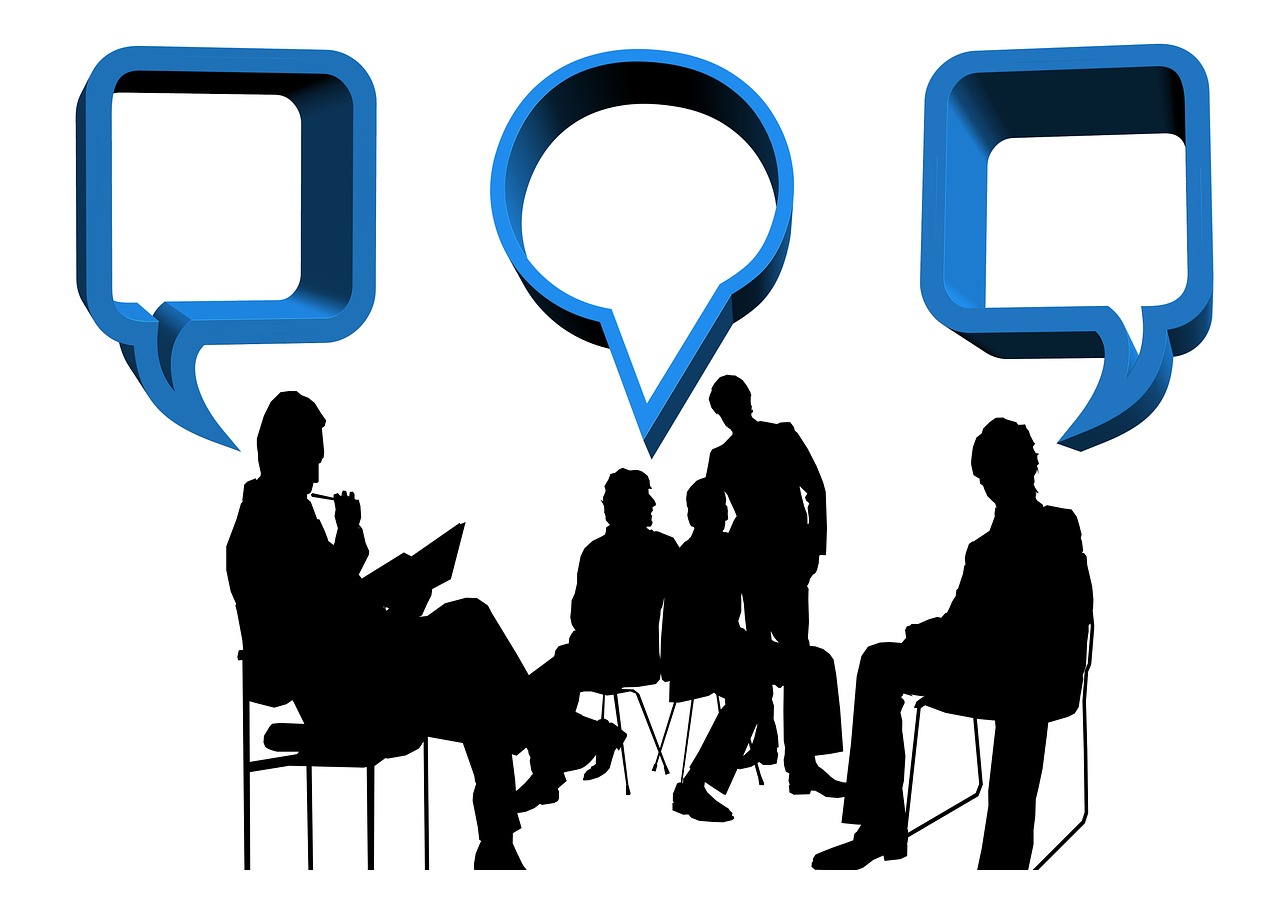 illustration of a number of people chatting, as if in a meeting/ consultation, with chat balloons | photo credit: Gerd Altmann via pixabay.com