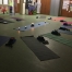 Setup of a Yoga for All Manchester session back in April 2019: yoga mats, candles, blocks in a dimly lighted room