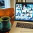 a laptop showing a virtual meeting and a mug on top of a wooden table | source: unsplash.com