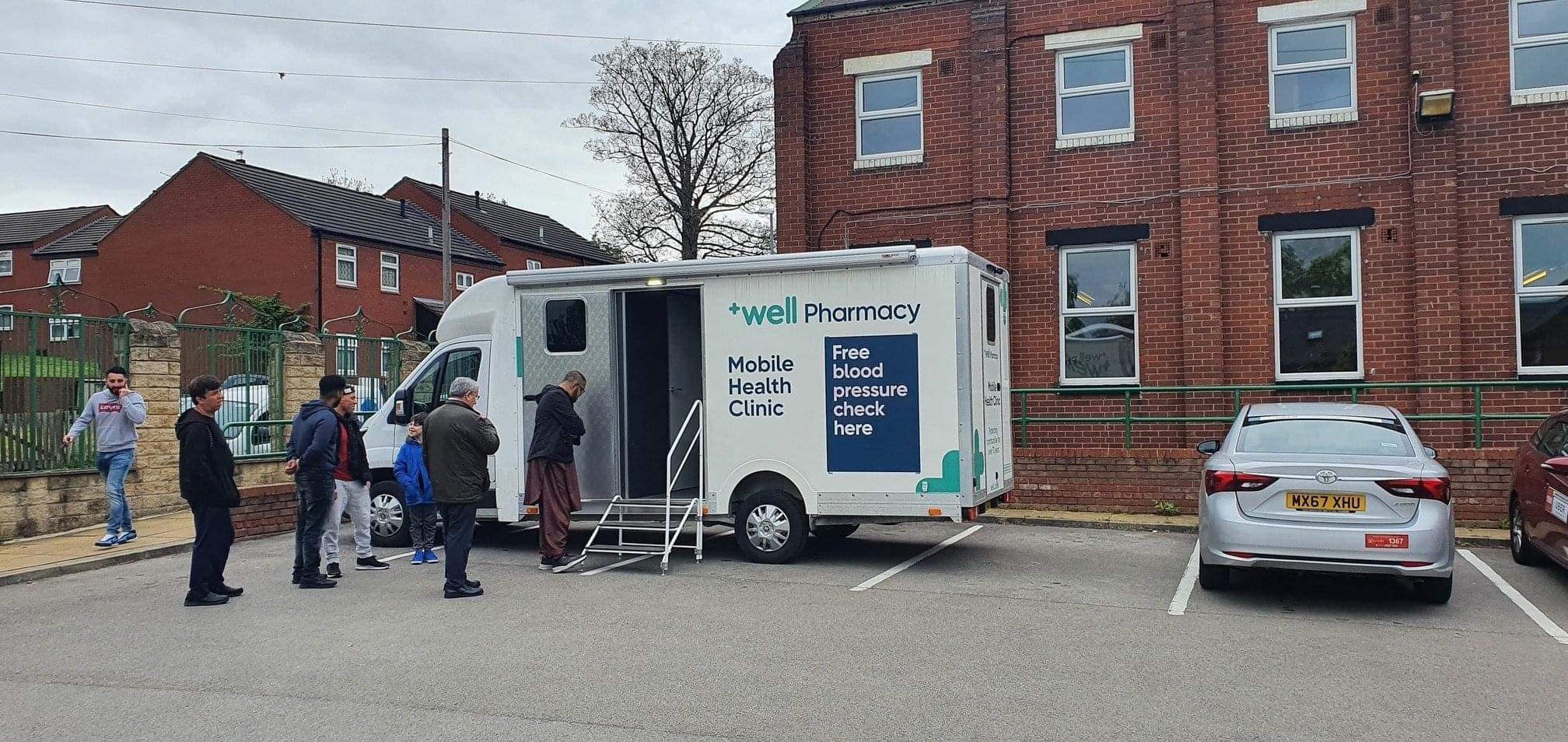 A Well Pharmacy mobile health clinic that says "Free blood pressure check here"