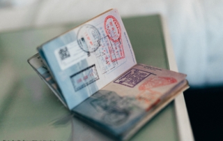 The photo shows an open passport with lots of stamped marks.