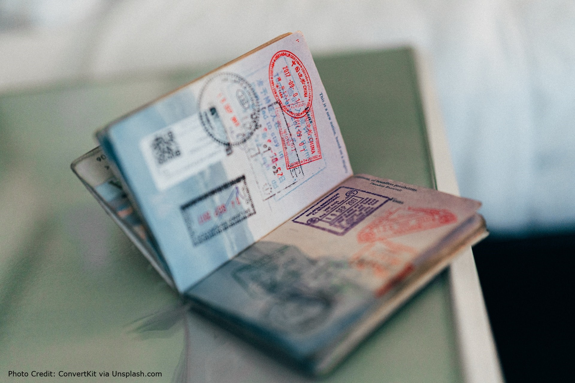 The photo shows an open passport with lots of stamped marks.