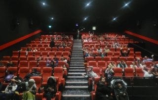 The image shows families in Cineworld Didsbury during our relaxed cinema session held in April 2023.