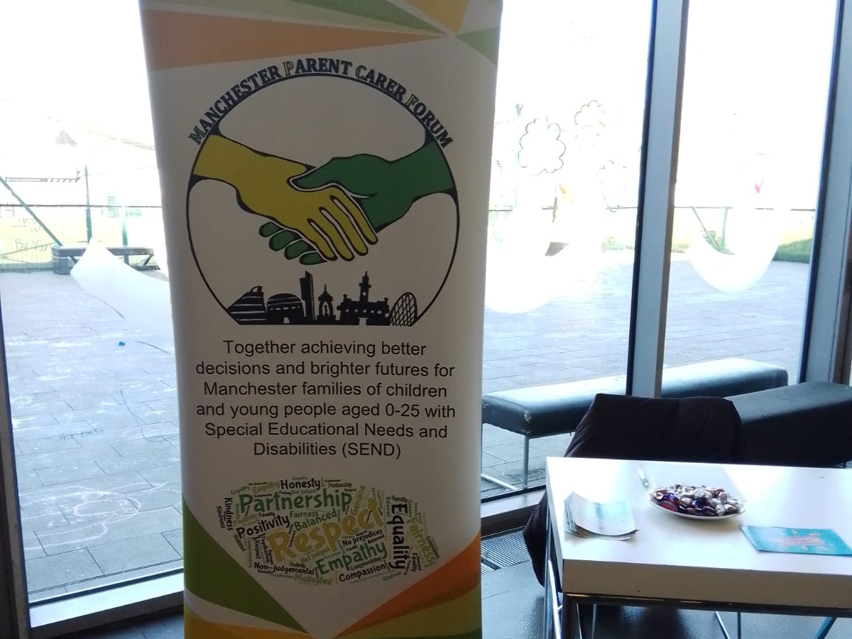 This photo shows the MPCF banner and table at the SEND Local Offer Drop-in at Moss Side Millenium Powerhouse in April 2023.