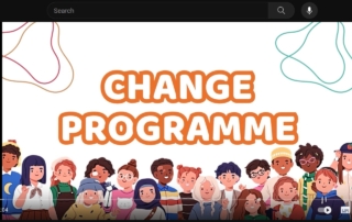 This screenshot of Manchester's Change Programme video shows the words "CHANGE PROGRAMME" in big, bold orange-and-white text, with an illustration of a diverse group of people under it.