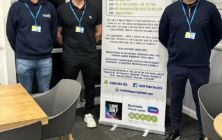 The photo shows John, Andy and Chris from SEND Dads Society surrounding their banner at the group's first session in March 2024.