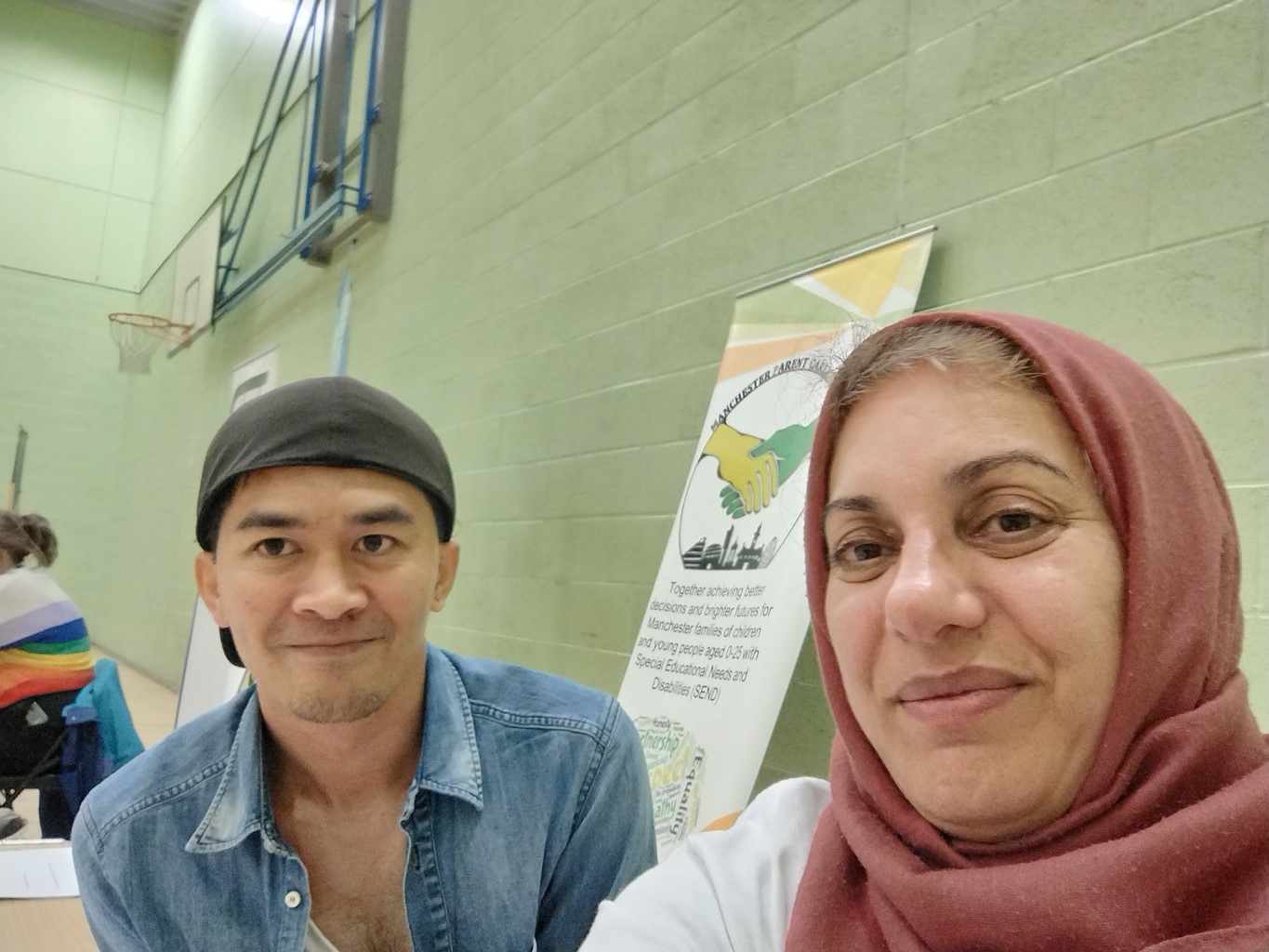 The photo shows Jordan (left) and Tara (right) from the MPCF team, with the forum banner behind them, at the Local Offer Drop-in @ Woodhouse Park Lifestyle Centre back in 25 September 2024.