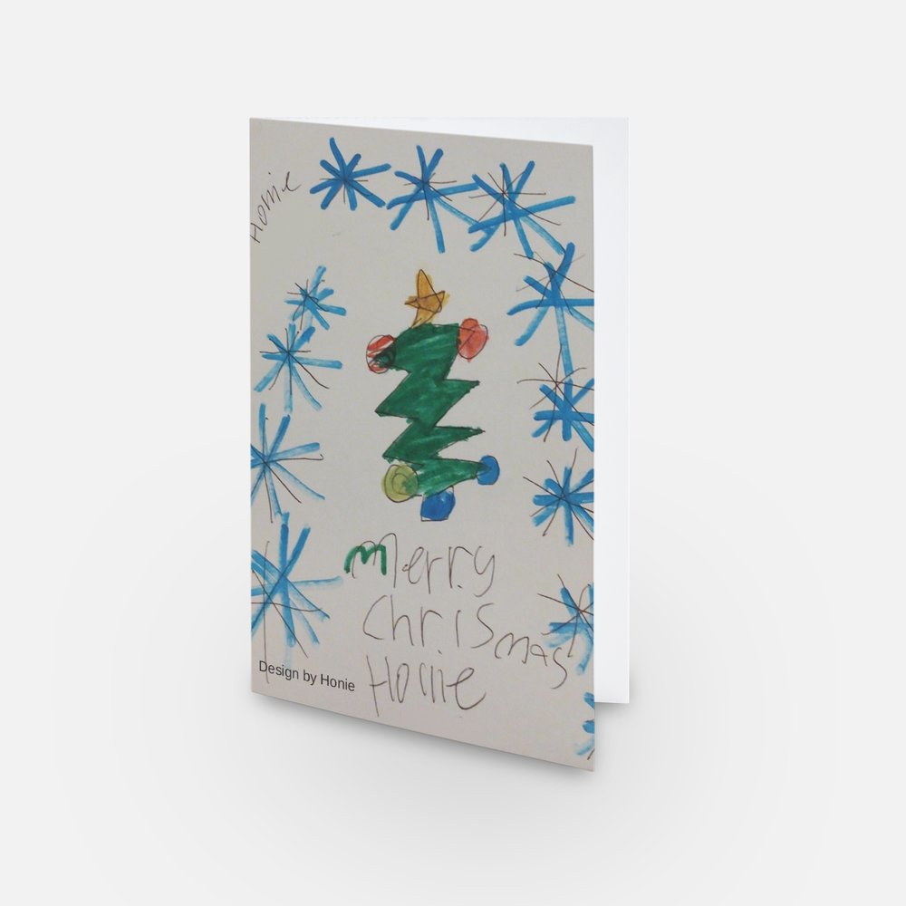 The image shows a mock-up of the festive card with Honie's design (showing a Christmas tree and snowflakes).
