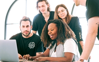 a woman showing her presentation to her colleagues | photo credit: pexels.com