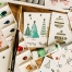 handcrafted Christmas cards and art materials on a table | image source: pexels.com