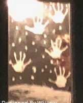 hand prints and falling snow, painted on a mirror