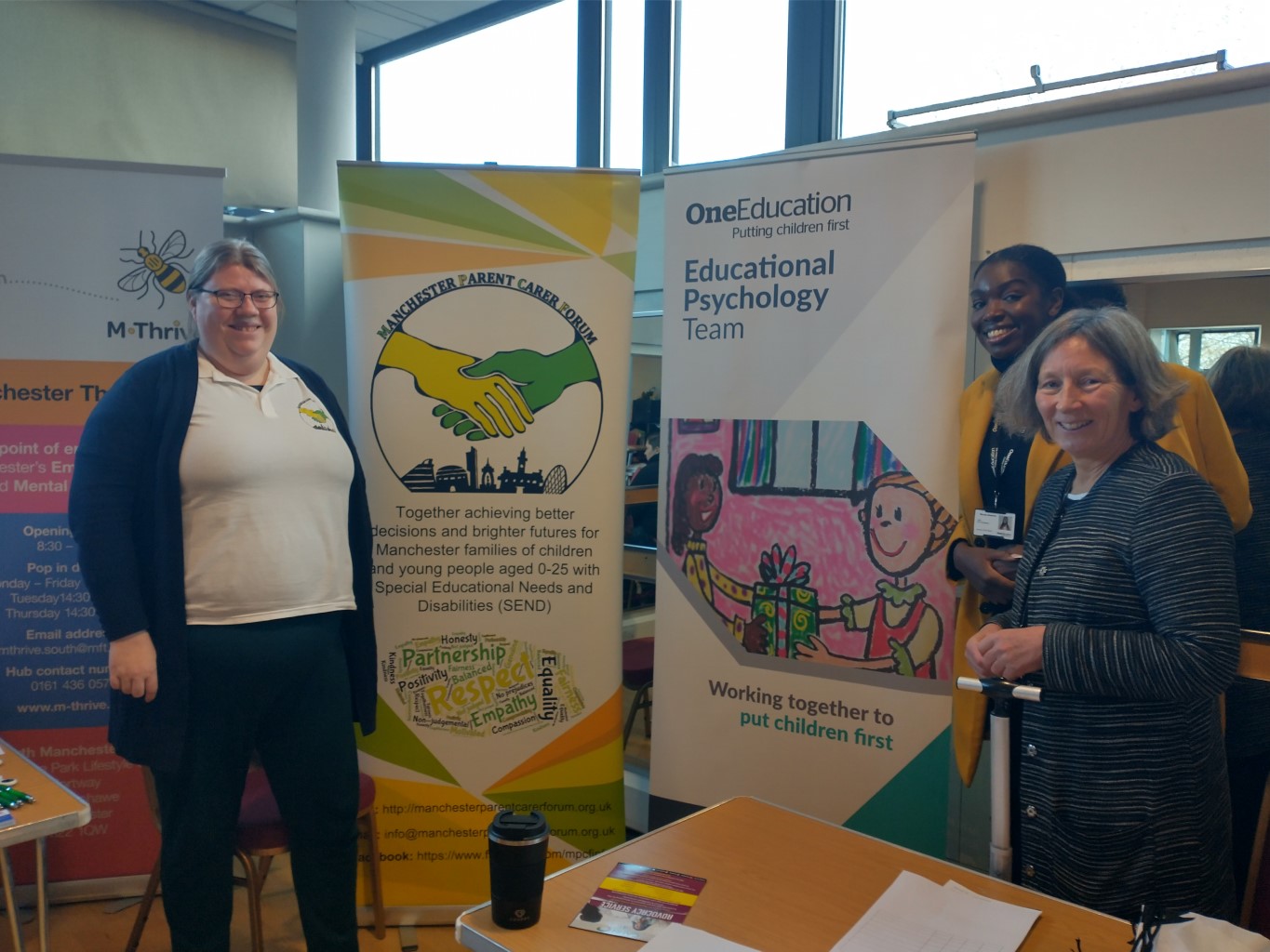 The photo shows Dawn (left) from the MPCF team with Abigail and her colleague from One Education standing next to the MPCF and One Ed banners at the Local Offer Drop-in @ Woodhouse Park Lifestyle Centre back in 16 Nov 2022.