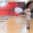 The image shows a young boy using a rack to bowl.
