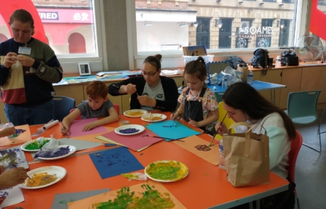 The photo shows a family enjoying the Relaxed Creative Session at Manchester Art Gallery in summer 2023.