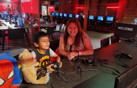 A boy and his mum enjoying a game at SIM's Power UP exhibition in spring 2023