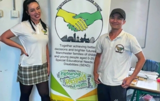 The photo shows Lia (left) and Jordan (right) from the MPCF team sandwiching the forum banner at the Local Offer Drop-in @ Manchester Settlement back in 9 July 2024.