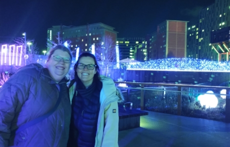 Two parent-carers posing with the lights at Twilight Trail in December 2023