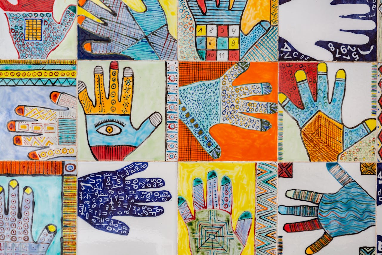 The photo shows a collage of differently coloured illustrations of hands with varying design intricacies.