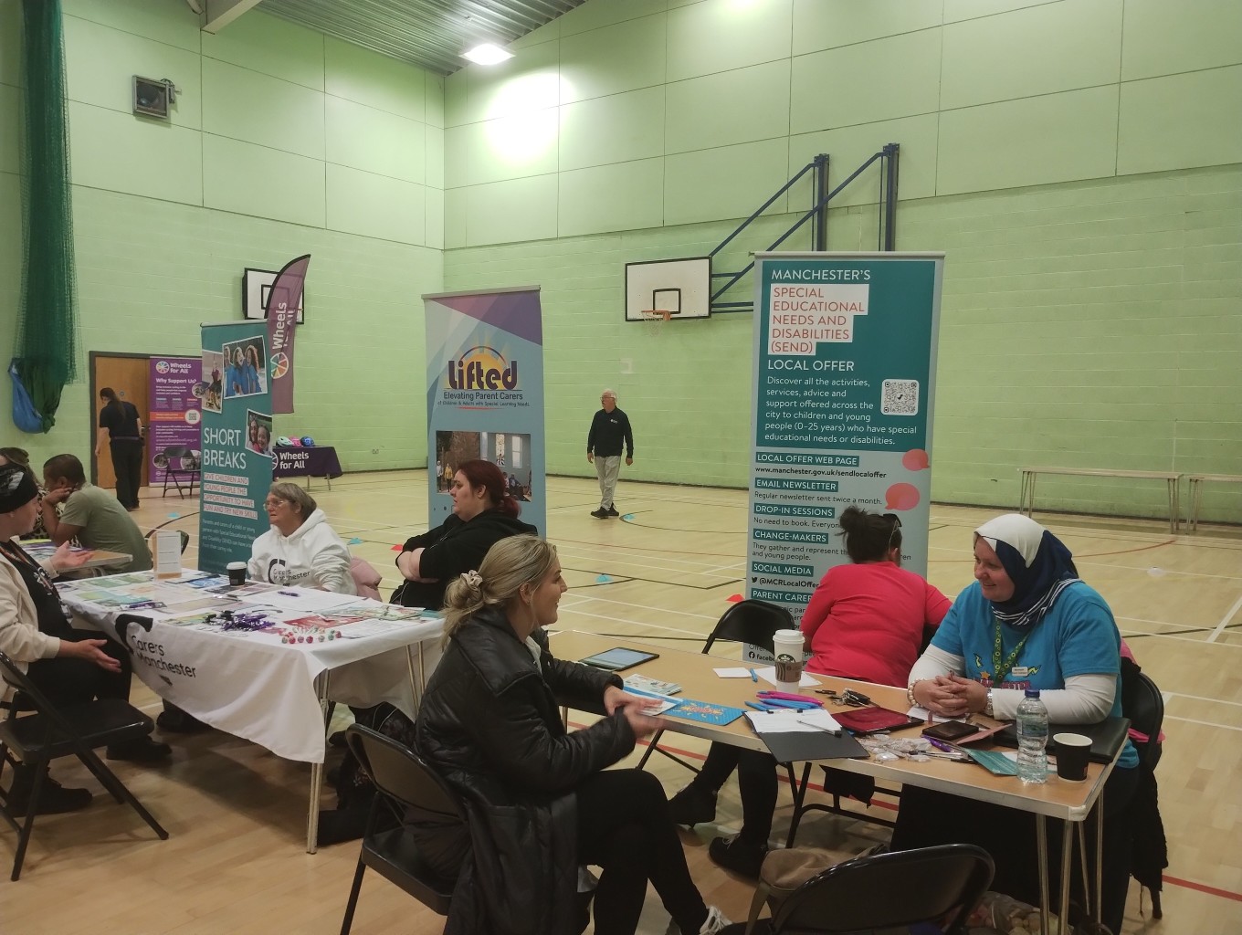 The photo shows various support organisations' / services' tables at the Local Offer Drop-in @ Moss SIde Powerhouse back in 10 September 2025.
