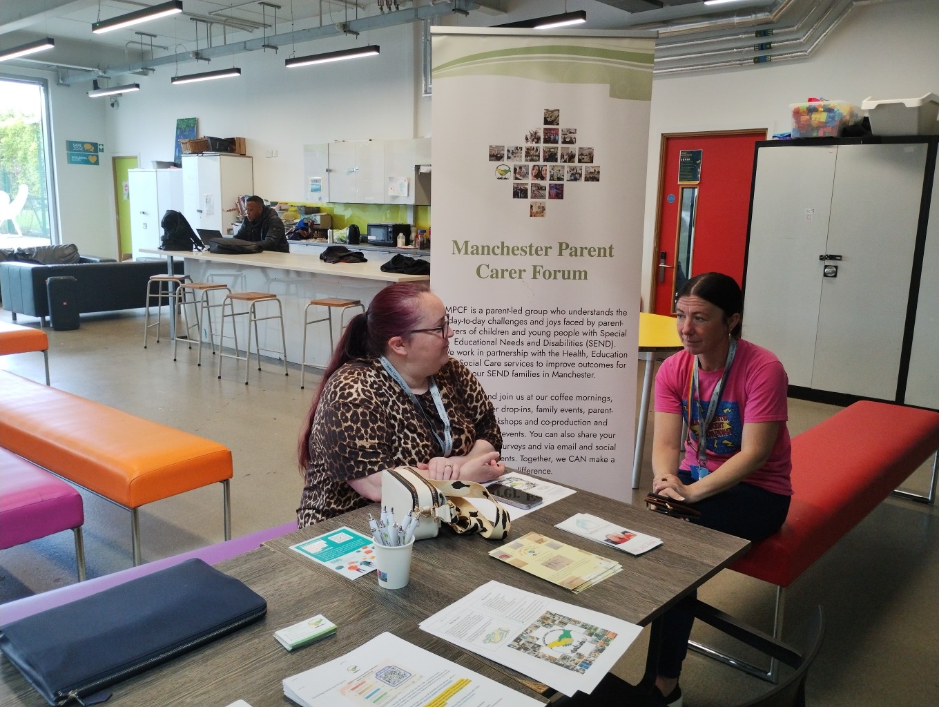 The photo shows Leanne (left) from the MPCF team and Tanya (right) from the Parent Champions sandwiching the forum banner at the Local Offer Drop-in @ Manchester Youth Zone on the 16th of July 2025.