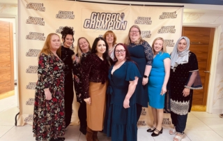 The photo shows the MPCF team posing with the backdrop of the Global Champion Awards of 2025.