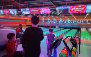 The photo shows some families enjoying a game of bowling during MPCF's SEND Community Offer inclusive session at Tenpin Harpurhey in December 2025.
