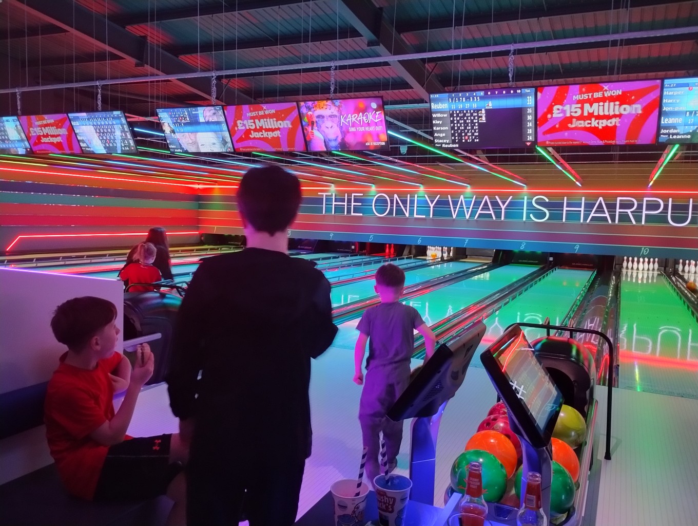 The photo shows some families enjoying a game of bowling during MPCF's SEND Community Offer inclusive session at Tenpin Harpurhey in December 2025.